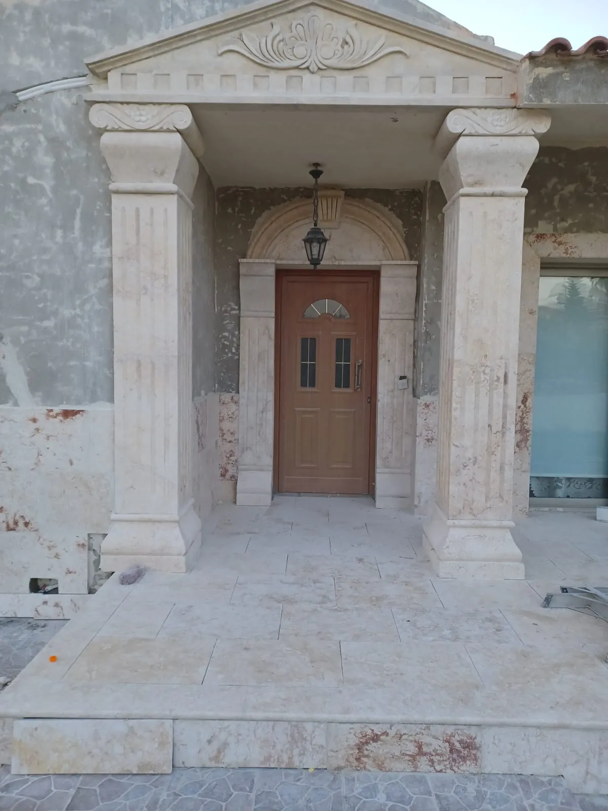 Stone columns and pediment framing a house entrance