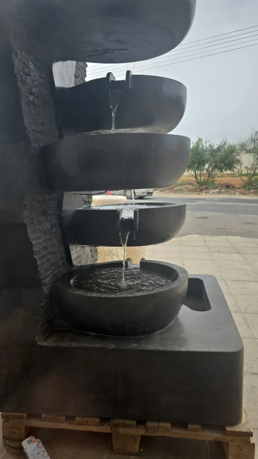 Dark stone cascade fountain with stacked bowls