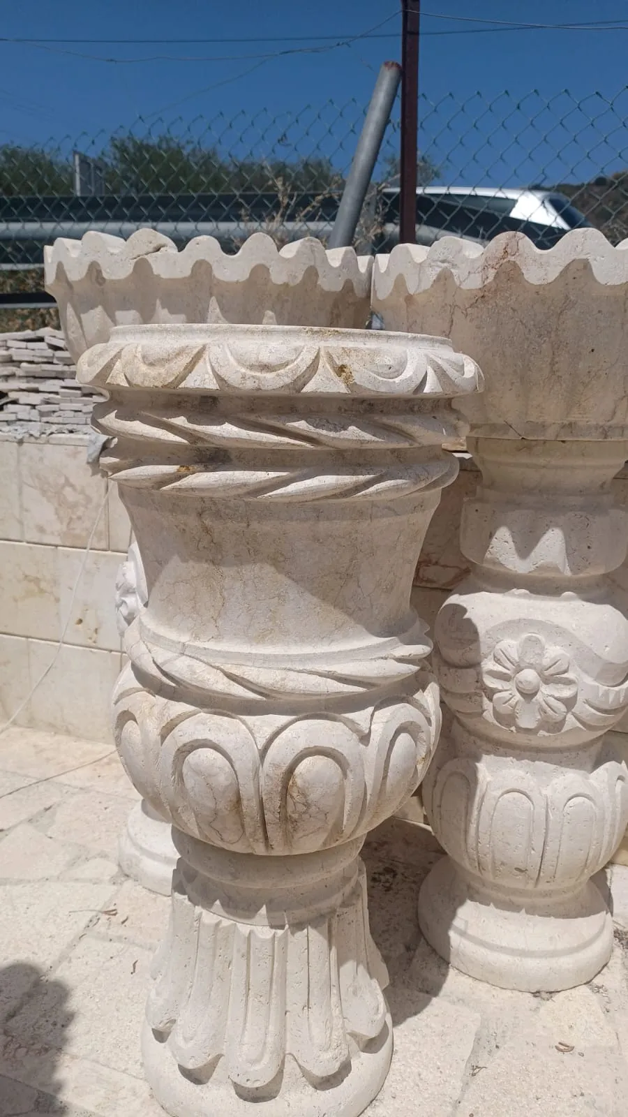 Carved detail on stone planters and column bases